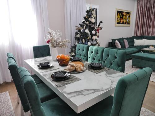 a living room with a table and a christmas tree at Golden view in Rrushkull