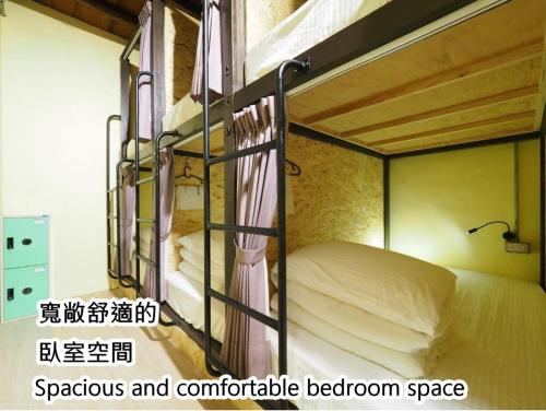 Postel nebo postele na pokoji v ubytování 公園一鹿背包客棧 Deer Park Hostel
