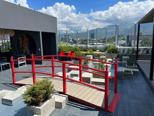 a deck with a red railing on top of a building at Top-floor overlooking uptown with AC & parking in San José