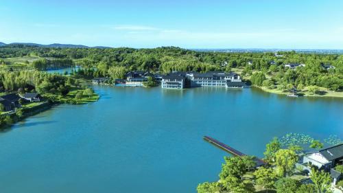 an aerial view of a lake with houses at 紫云玄清酒店 ZiYunXuanQing Resort&Spa 