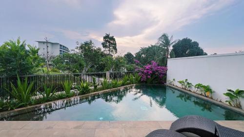 a swimming pool in front of a fence at Novus Jiva Anyer in Anyer