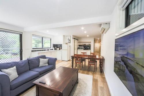 a living room with a couch and a table at Warburton Trails Accommodation in Warburton
