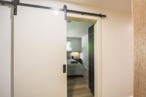 a sliding door leading into a room with a bed at Warburton Trails Accommodation in Warburton
