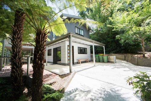 a house with a patio and a palm tree at Warburton Trails Accommodation in Warburton