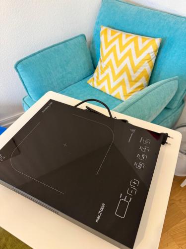 a laptop sitting on a table next to a couch at City Center Rooftop Studio with Oldtown View in Basel