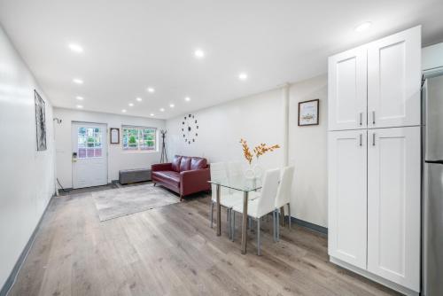 a living room with a glass table and a couch at Jetted Tub Stay in Passaic