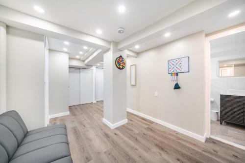 a living room with a couch and art on the wall at Jetted Tub Stay in Passaic