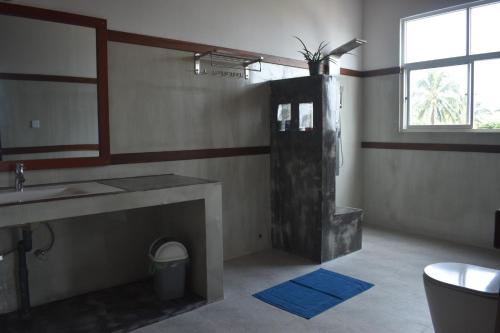a bathroom with a shower and a sink at Hotel Ocean View Cottage in Hikkaduwa