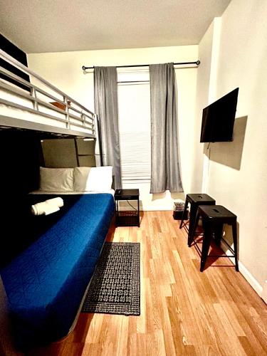 a bedroom with a blue bed and a window at Stay Chicago in Chicago