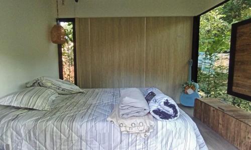 a bedroom with a bed with pillows and a window at House Viotá in Viotá