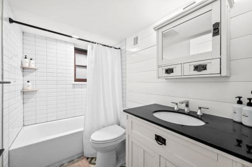 a white bathroom with a sink and a toilet at Downtown Stay off Broadway Nightlife Nearby Parking in Denver