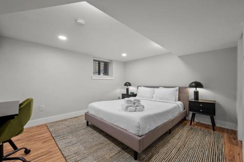a white bedroom with a bed and a desk at Downtown Stay off Broadway Nightlife Nearby Parking in Denver