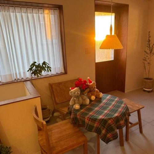 two teddy bears sitting on a table in a room at 영도 여는 in Busan