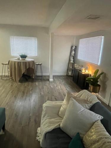 a living room with a couch and a table at Sofi Intuit Forum Vacation Oasis in Los Angeles