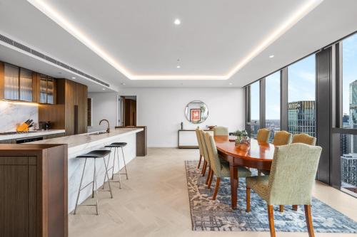 a kitchen and dining room with a table and chairs at Collins House Apartments by CLLIX in Melbourne