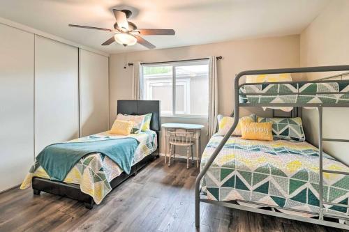 a bedroom with two bunk beds and a ceiling fan at NEW Pool Spa Firepit Pool Table Sleeps 12 in Lake Havasu City