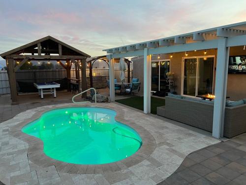 a swimming pool in the middle of a patio at NEW Pool Spa Firepit Pool Table Sleeps 12 in Lake Havasu City