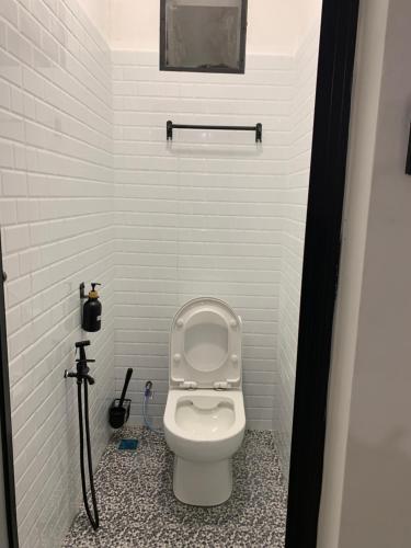 a bathroom with a toilet with the lid up at RumaTisa in Teluk Intan
