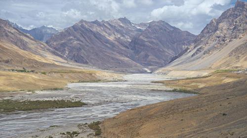 a river in the middle of a mountain range at Echor Mud Huts Tabo, Spiti Valley in Kaza