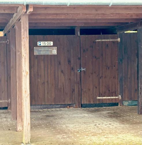 a large wooden door with a sign in front of it at Ostseebrise-Fehmarn in Fehmarn