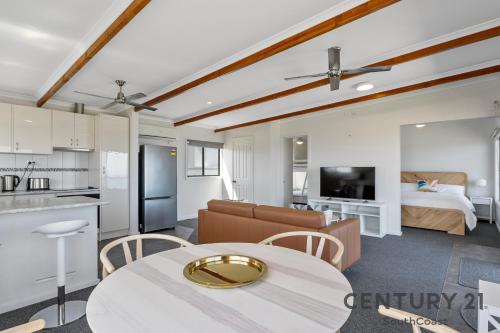 a room with a kitchen and a living room at See-Sea House - Sellicks Beach - C21 SouthCoast Holidays in Sellicks Beach