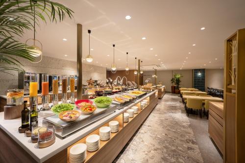 a buffet line in a restaurant with food on display at Namba Oriental Hotel in Osaka