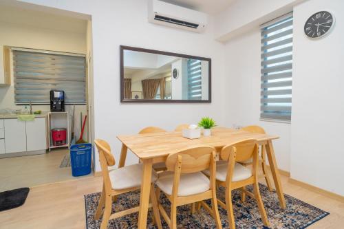 a dining room with a wooden table and chairs at Twynstar Mutiara Melaka Beach Resort in Tangga Batu
