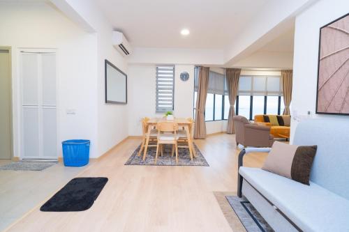 a living room with a table and a couch at Twynstar Mutiara Melaka Beach Resort in Tangga Batu
