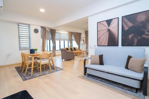a living room with a couch and a table at Twynstar Mutiara Melaka Beach Resort in Tangga Batu