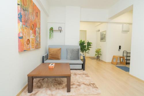 a living room with a couch and a table at Twynstar Mutiara Melaka Beach Resort in Tangga Batu