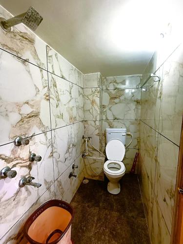 a dirty bathroom with a toilet and a sink at Hotel Shreem in Ujjain