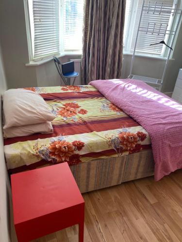 a bedroom with a bed and a red table at Private Lovely double bedroom in High Wycombe