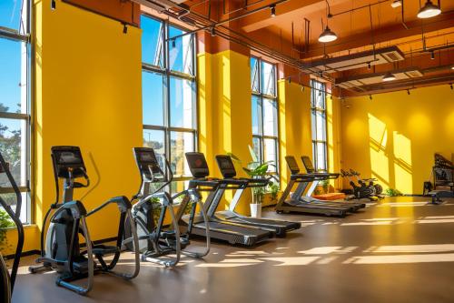 a gym with yellow walls and treadmills at Xikang Wellness & Resort Qingcheng Mountain in Taiping