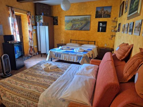 a living room with two beds and a couch at A Casa da Nonna Brasa Holiday Home Savoca in Savoca