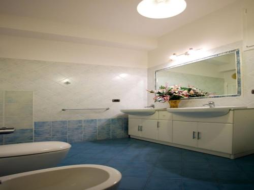 a bathroom with two sinks and a mirror and a toilet at San Firenze in Florence