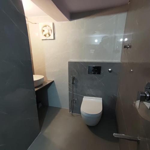 a bathroom with a toilet and a sink at Marwa House in Jaipur
