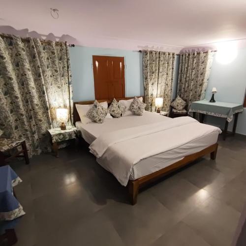 a bedroom with a large bed and a sink at Marwa House in Jaipur