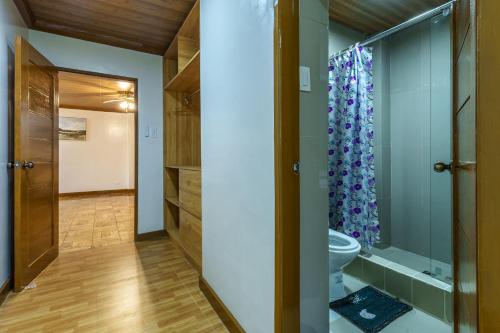 a bathroom with a toilet and a shower at Luxury Residence #1 Camp John Hay nr Eco Trails in Baguio