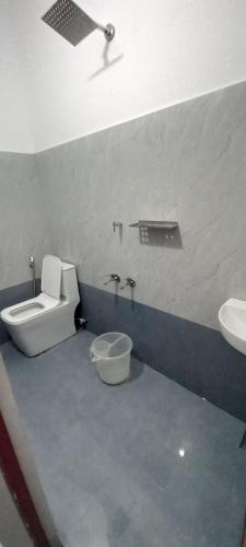 a bathroom with a toilet and a bidet and a sink at AMAN Residency in Kallar Vattiyar