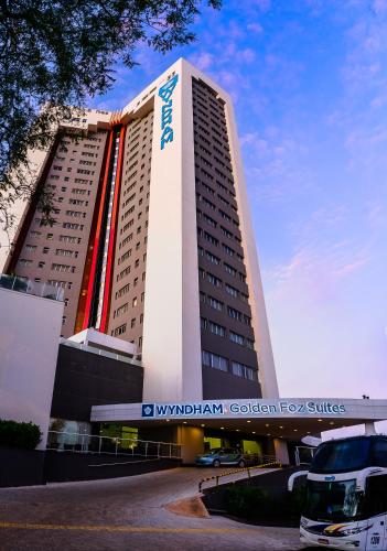 a building with a sign on the side of it at Wyndham Golden Foz Suítes in Foz do Iguaçu