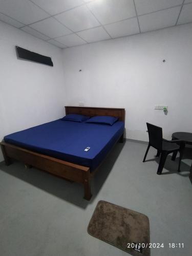 a bedroom with a bed and two chairs and a table at Digital Nomads in Weligama