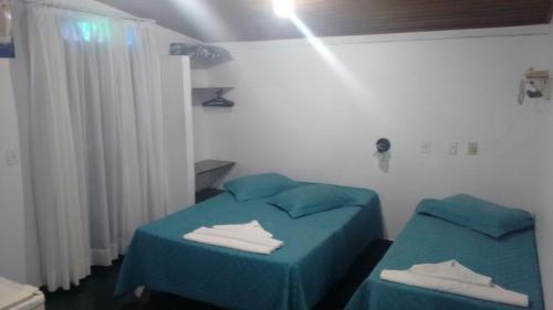 Giường trong phòng chung tại Pousada da Memeia