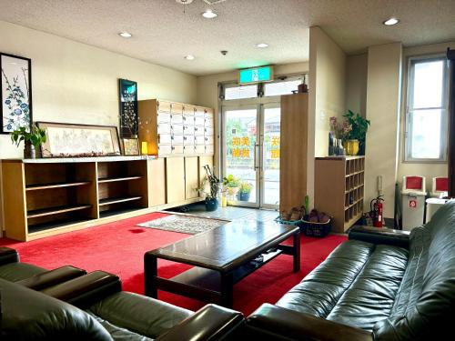 a living room with a couch and a coffee table at 美咲旅館 in Sakaide