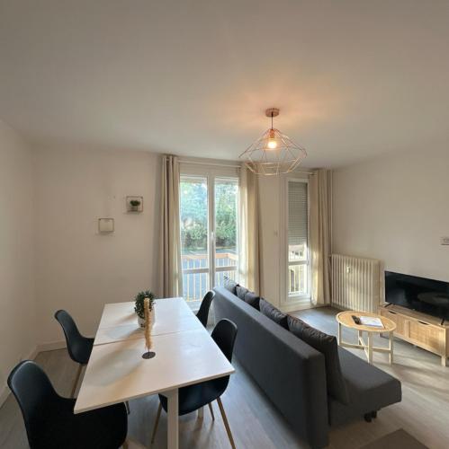 a living room with a couch and a table at Repère cosy in Saint-Brieuc