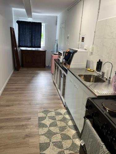 a kitchen with a sink and a counter top at Twinkle Orchard Camp in Taupaki