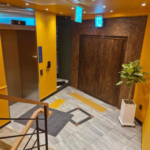 a lobby with a door and a potted plant at Bluedot Poshtel in Seoul