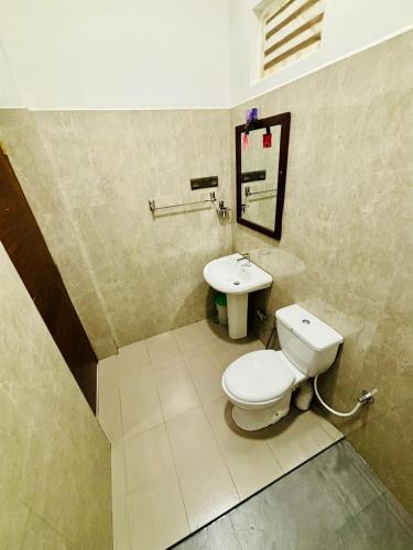 a bathroom with a toilet and a sink at Anuradhapura Kingdom View Resort in Anuradhapura