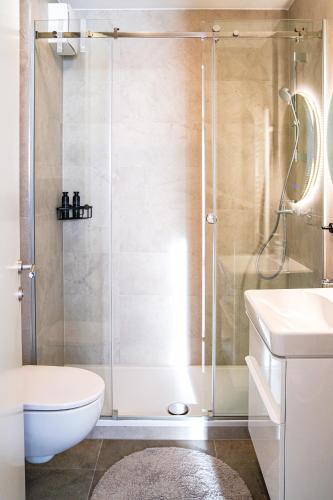 a bathroom with a shower with a toilet and a sink at Apartment Stefani Zadar - Balcony & Free Private Garage Parking in Zadar