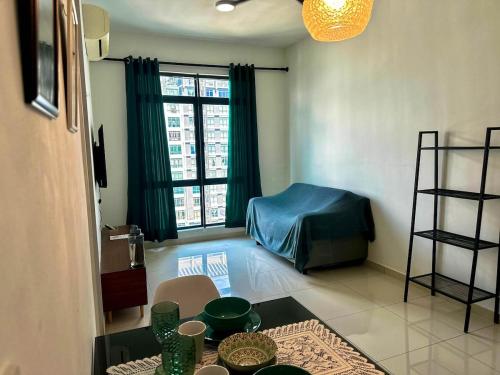 a living room with a table and a room with a bed at Kenwingston Cyberjaya Wifi Free Parking in Cyberjaya