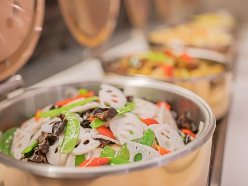 a bowl of food sitting on a table at Xiangyang Station Minfa World City Yishang Plus Hotel in Xiangyang